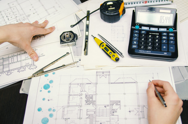 man-engineer-working-his-building-plans-using-pencil-calculator_6602-454.jpg